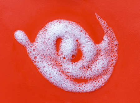 Soap foam on a red backgroundの写真素材