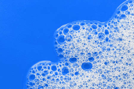Soap foam on a bright blue background