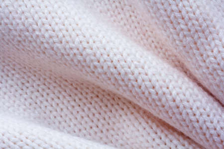 Simple knitted fabric made of pink yarn with large foldsの写真素材