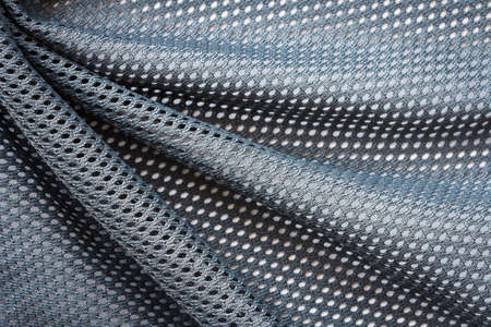 wrinkled gray mesh sport fabric with large diagonal foldsの写真素材