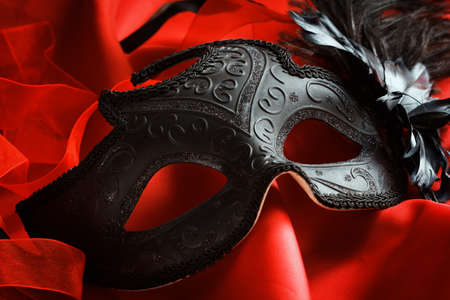 Carnival venetian mask on a bright red backgroundの写真素材