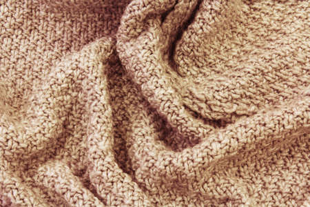 Knitted brown fabric texture with large fold