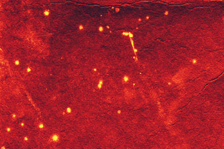 old rough red background with flashes and cracksの写真素材