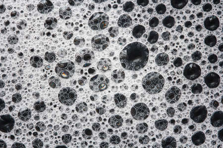 soap foam on a black backgroundの写真素材