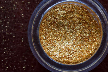 eye gold shadows in a opened box on a dark brown surfaceの写真素材