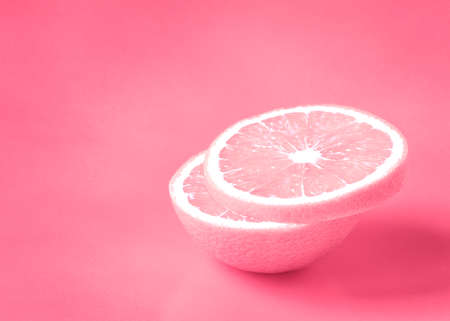 pink sliced orange on pastel vanilla backgroundの写真素材