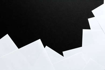 sheets of white paper on a black background