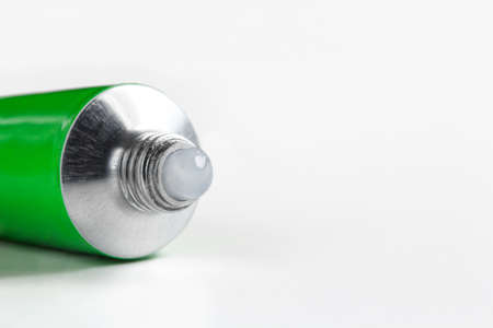 open tube of ointment on a white background with copy spaceの写真素材