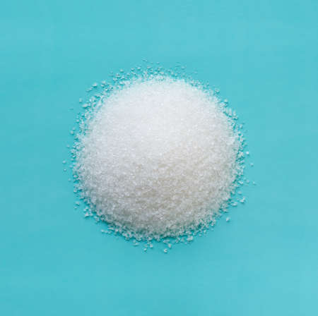 heap of sugar in the shape of a circle on a blue background