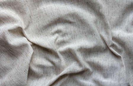 natural crumpled linen fabric as textile backgroundの写真素材
