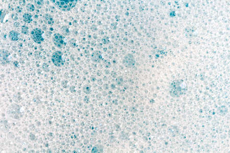 soap foam on light blue background, lather textureの写真素材