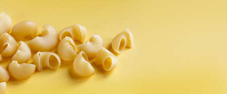 dry uncooked italian pasta lumaconi on a white background wiht copy spaceの写真素材