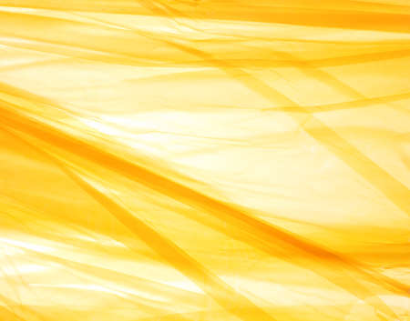 bright abstract background, crumpled yellow plastic bag