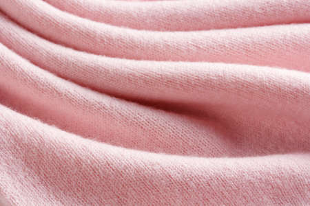 Knitted cashmere pink fabric texture with large foldの写真素材