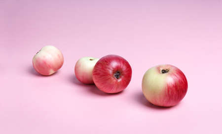 apples on a pink background with place for text