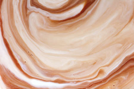 mixing coffee with milk,background macroの写真素材