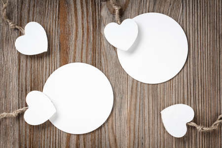 hearts with two white paper labels on a old wooden backgroundの写真素材
