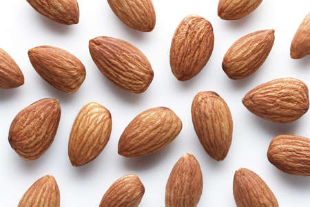 whole shelled almonds on white background 