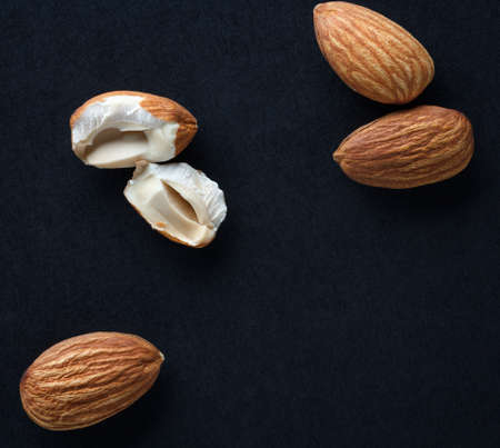 almonds on black background with copy spaceの写真素材