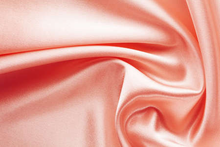 shining red fabric with large folds, textile backgroundの写真素材