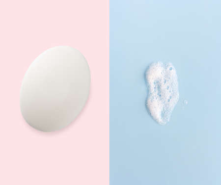 toilet soap and lathe foam on light blue pink background, hygiene conceptの写真素材