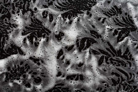 soap foam on black background, lather textureの写真素材