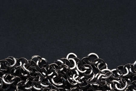 dark metal chain on black background with copy space