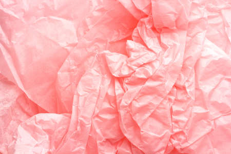 crumpled bright pink wrapping paper as backgroundの写真素材