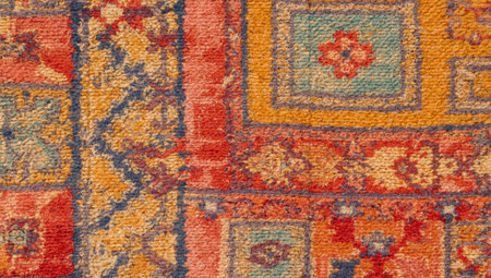 fragment of a carpet with a traditional oriental ornament, bright colors, geometric and floral motifsの素材