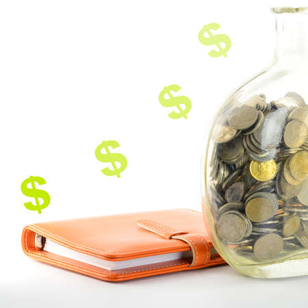coins in old money jar on white background の写真素材