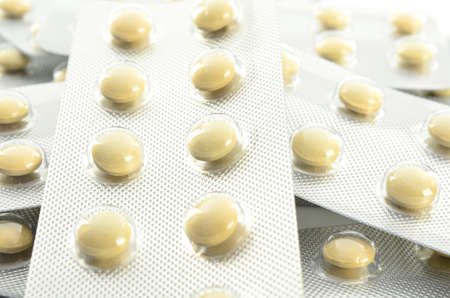 Pills in blister packs on white backgroundの写真素材