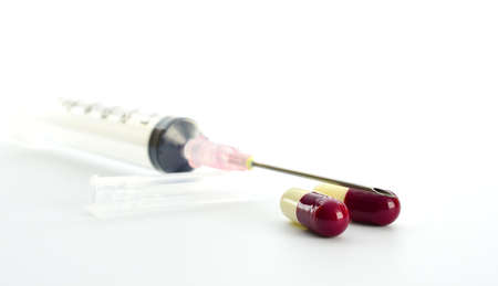 capsules and needle on white backgroundの写真素材