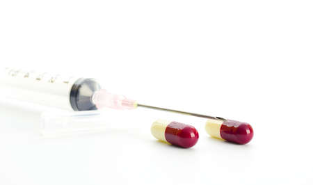 capsules and needle on white backgroundの写真素材