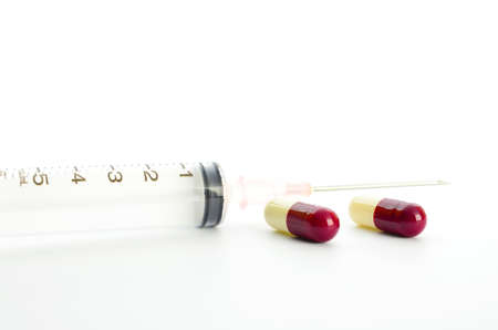 capsules and syringe on white backgroundの写真素材