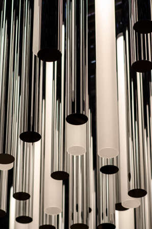Metal lamp holder in vertical texture play with light and shadowsの写真素材
