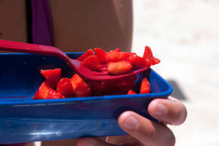 fork ready to eat strawberries in piecesの写真素材