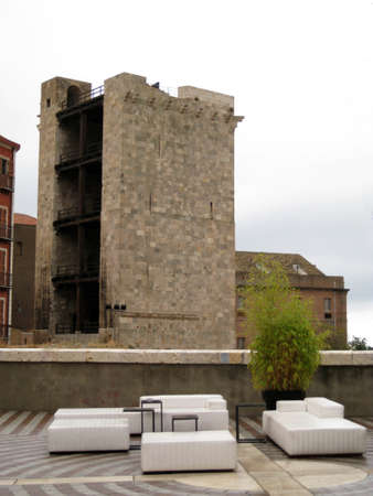 scene in the medieval village with a sitting bar with lookout tower in the backgroundの写真素材