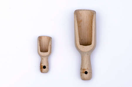 Two wooden scoops one small and one large used as dosage,  isolated on white backgroundの写真素材