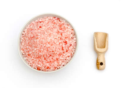 bowl full of bath salts with pink and white grainsの写真素材