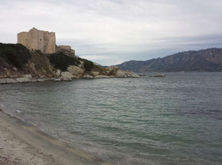 A Castle in front of the sea in a cloudy day  in Villasimiusの写真素材