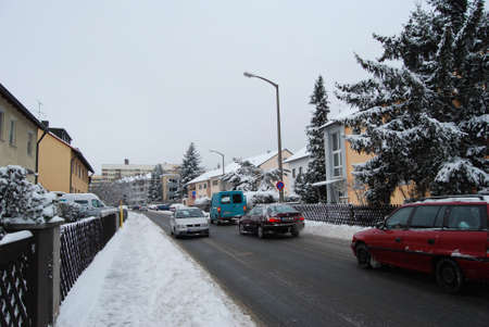 Erlangen,  Germany -DECEMBER 18: Snow-covered residential street daily in with some cars  on December 18.2010 in Erlangen, Germany  as editorialのeditorial素材