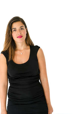 Lovely caucasian young girl posing in front of the camera with long hair, black dress and simple make upの写真素材