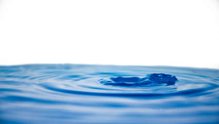 Drop effect on water. Rings / crown of water bluish with white backgroundの写真素材