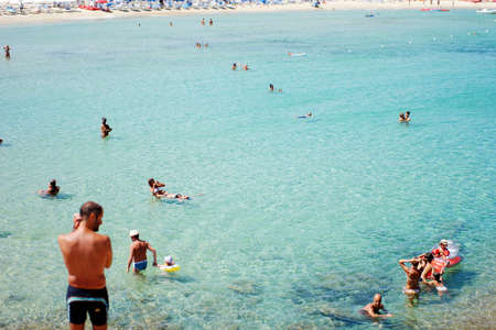 Costa Rei, Italy - August 25: Unidentified people in beach called Scoglio di Peppino. Sunny day in summertime, crystal water like a natural pool on August 25.2015 in Costa Rei, Italy as editorialのeditorial素材