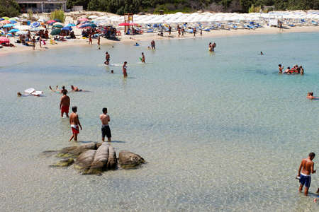 Costa Rei, Italy - August 25: Unidentified people in beach called Scoglio di Peppino. Sunny day in summertime, crystal water like a natural pool on August 25.2015 in Costa Rei, Italy as editorialのeditorial素材