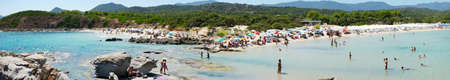 Costa Rei, Italy - August 25: Unidentified people in beach called Scoglio di Peppino. Panoramic view, sunny day in summertime, crystal water like a natural pool on August 25.2015 in Costa Rei, Italy as editorialのeditorial素材