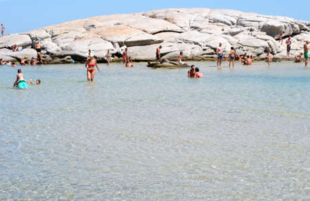 Costa Rei, Italy - August 25: Unidentified people in beach called Scoglio di Peppino. Sunny day in summertime, crystal water like a natural pool on August 25.2015 in Costa Rei, Italy as editorialのeditorial素材