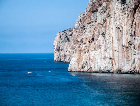 Masua's sea stack daily and some boats in summertime. Sardinian coast (Italy)の写真素材