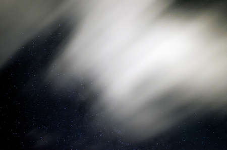 Sky in the night with stars and clouds blurry beccause they are in long exposure in summertimeの写真素材