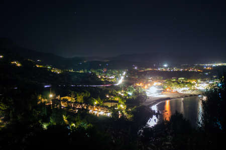 Coastal Landscape in the night with lights, colors, hills and beach. Villasimius Campus Details (Sardinia)の写真素材